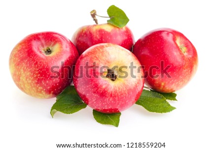 Ripe red apples with green leaves isolated on white background.
