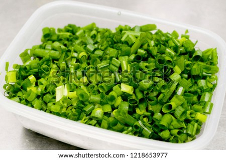 chopped green onions in  Plastic food containers
