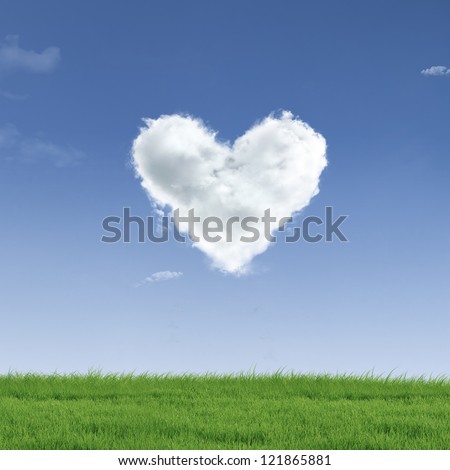 Picture of a a heart cloud on blue sky  and green field