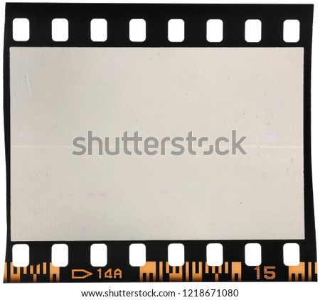 Real macro photo of 35mm dia film frame or strip on white with signs of usage, dust and film grain