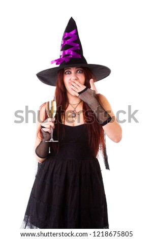 Picture of laughing witch in black hat, with glass of champagne