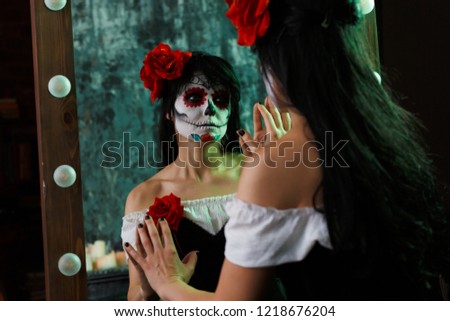 Image of witch girl with white face and red flower on her head