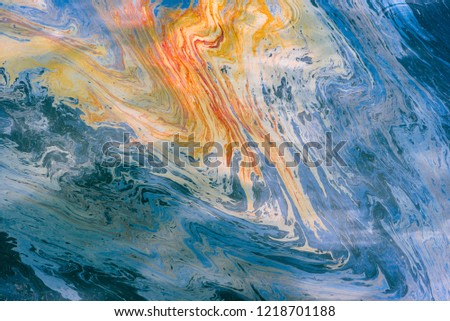 abstract image of multi-colored oil and gasoline stains on the water. psychedelic background or texture