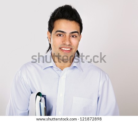 A young man with books, isolated on white background