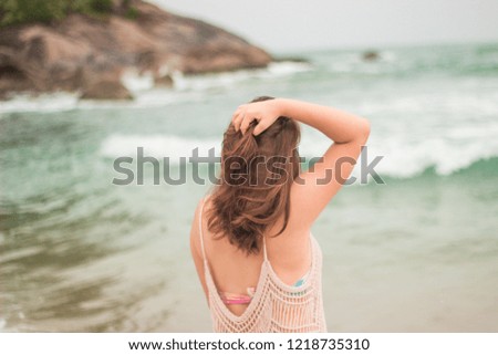 Woman holding her hair at the beach