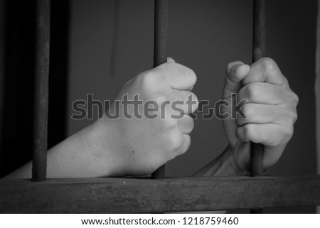 Close up of hands is imprisoned in a prison,Prison prisoner concept.Punish the offender.