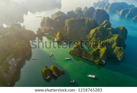 Aerial view floating fishing village and rock island, Halong Bay, Vietnam, Southeast Asia. UNESCO World Heritage Site. Junk boat cruise to Ha Long Bay. Popular landmark, famous destination of Vietnam
