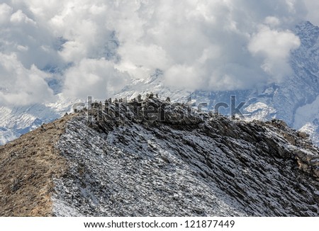 View at the top of the mountain Chhukhung Ri with stone pyramids in the background of the massif of the Ama Dabla - Everest region, Nepal