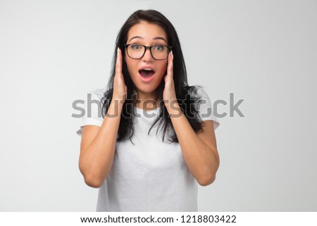 surprised woman in glasses after hearing shocking information. close up photo. amazement concept. copy space