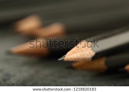 Sharpened black pencil graphite tip - abstract image backgrounds.