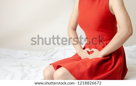 Women wear red skirt Use the hand to scratch the vagina.Genital itching caused by fungus in underwear.Do not focus on objects. Royalty-Free Stock Photo #1218826672