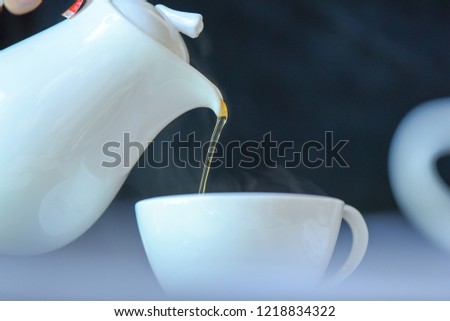 side view of a male pouring tea