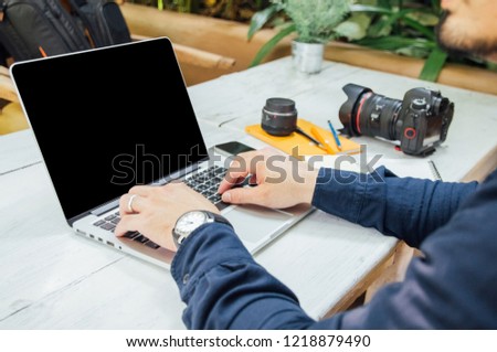 newsletter concept Hand of businessman or designer checking message box on digital laptop, blank black space for your text
