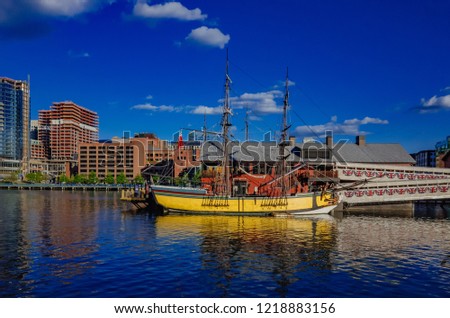 View of Boston Tea Party Ship & Museum over Fort Point Channel under blue sky in downtown Boston, USA Royalty-Free Stock Photo #1218883156