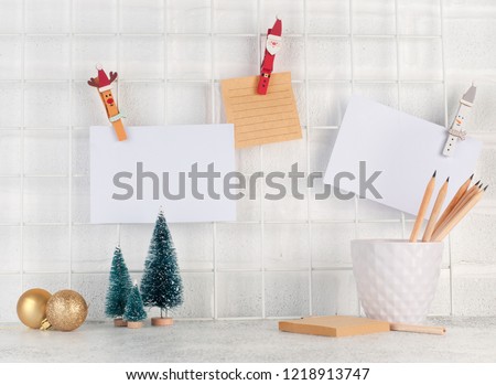 Mood board with empty cards on it near Christmas trees and balls.