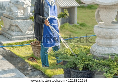 Workers watering planters workers