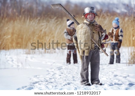 Group of boys go hockey on a local lake in winter