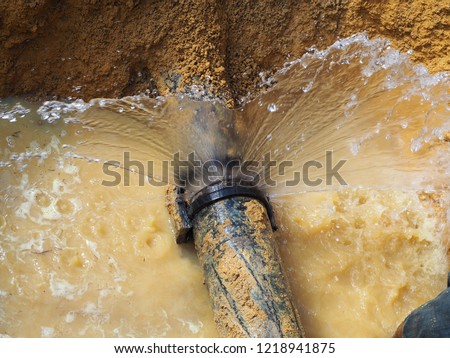 Main pipe burst at socket joint Royalty-Free Stock Photo #1218941875