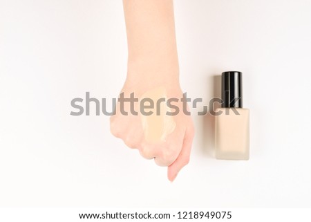 Swatch  of foundation on the hand isolated on white.