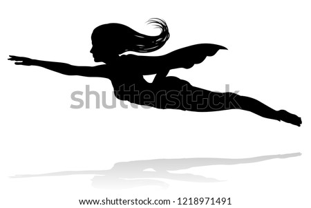 A woman caped superhero flying in silhouette