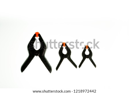 Black industrial clamps isolated against white background. 