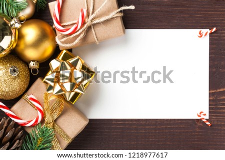 Christmas card with gift boxes and christmas ornament on wooden background