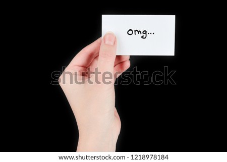 Omg text on a card in woman  on a black background.