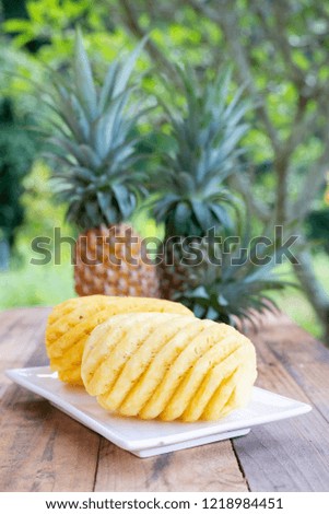 Pineapple on the wooden texture background