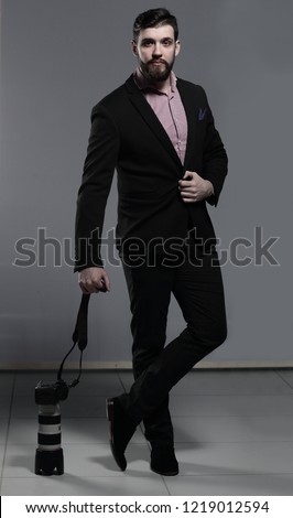professional photographer puts the camera on the floor.isolated on grey background