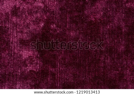 Saturated violet velvet background with shiny surface. High resolution photo.