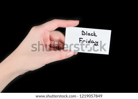 Black friday text on a card in woman  on a black background.