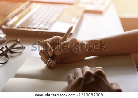 Asian young business man of student holding a pen writing letter on paper at home