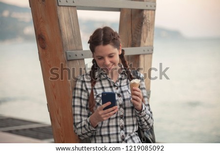 cute redhead girl reads messages in the phone