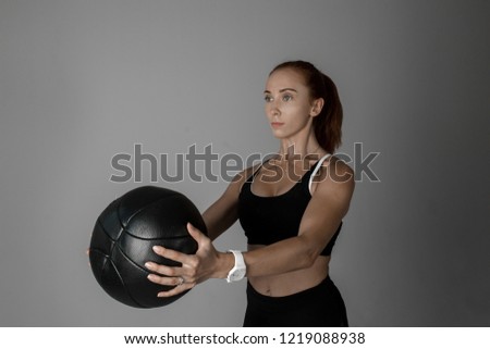 young girl doing sports with ball on white background