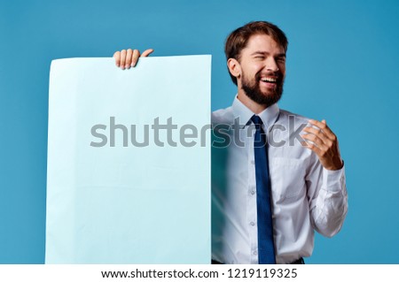 blue bearded man background with white sheet of paper                               