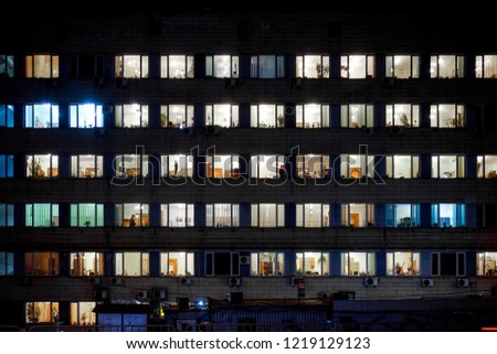 many windows with light as night building pattern Royalty-Free Stock Photo #1219129123