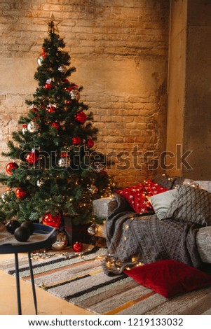 Decorated Christmas room with beautiful fir tree near the window