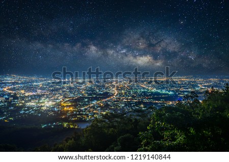 aerial view City night from the view point on top of mountain with milky way and stars field background , Chiang mai ,Thailand
