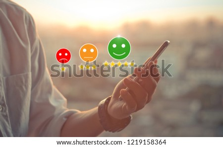 customer experience concept.Man hands holding mobile phone on blurred urban city as background Royalty-Free Stock Photo #1219158364