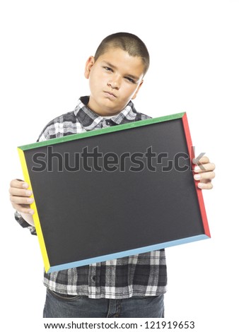 A grumpy looking boy holding up a chalk board