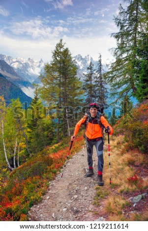 Mont Blanc Chamonix autumn - picturesque meadows of highland berry bushes are fantastically beautiful after the first frosts against  background of steep peaks of the Alps. Self portrait