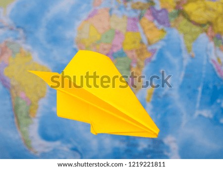 paper plane flies world map travel