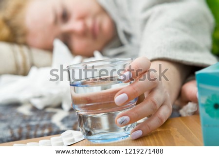 Sick and tired young woman lying on bed, closeup