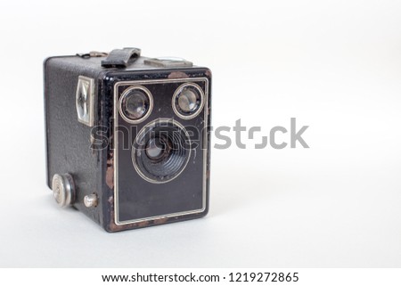 Simple and inexpensive Basic cardboard box camera with a simple meniscus lens isolated on white with shadow