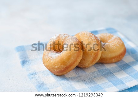 Homemade classic donuts on a light background. Breakfast concept. Copy space. Selective focus