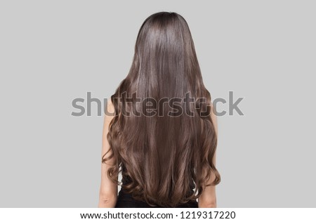 Woman with long dark hair. Shiny wavy hair