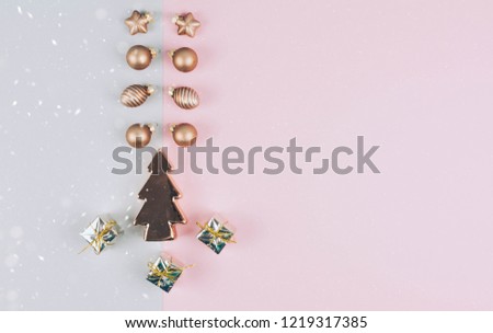Christmas tree balls on a gay and pink background with a place for your text. Minimal holiday concept.