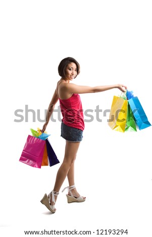 An isolated shot of a beautiful black woman carrying shopping bags