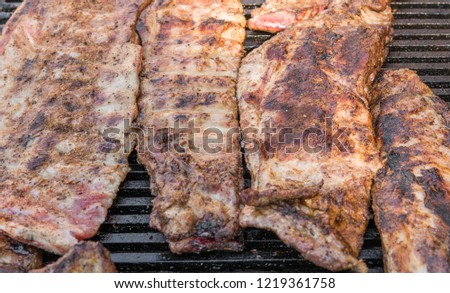 Cooking pork ribs on a grill. Meat on a grills.