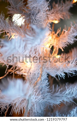 White Christmas tree closeup on a blue background. Christmas photo.